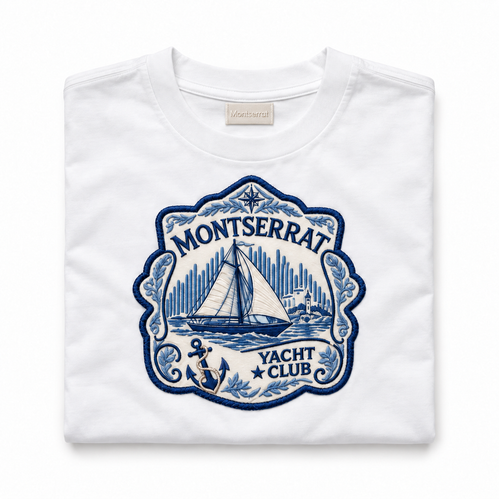 A folded white crewneck t-shirt with a large blue embroidered patch on the front reading 'Montserrat Yacht Club' with a sailboat illustration.
